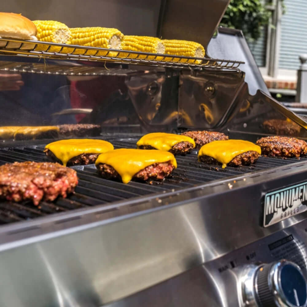 Burgers and corn on the Monument Grills grates